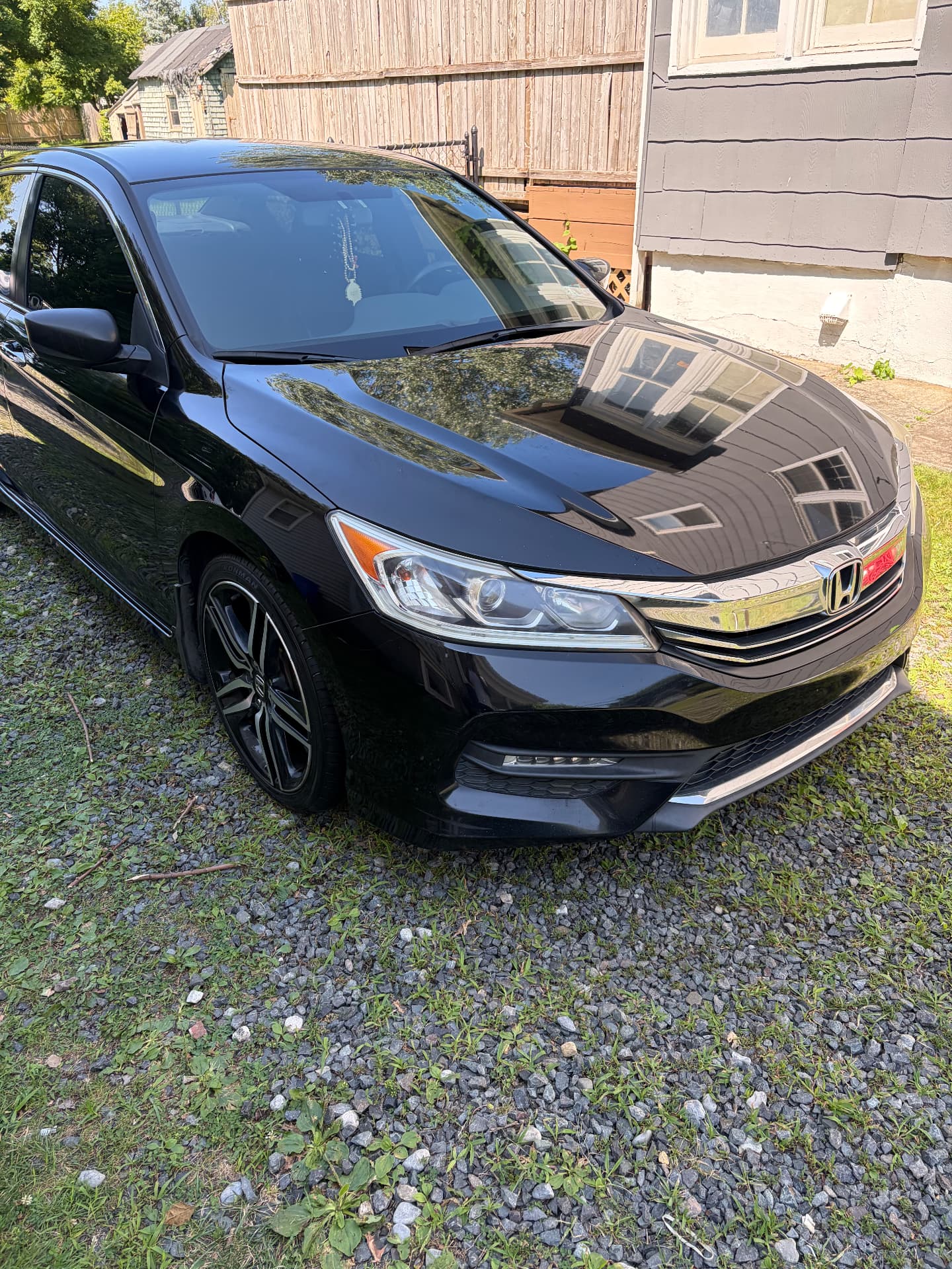 Black Honda Accord with a mirror-gloss finish after detailing